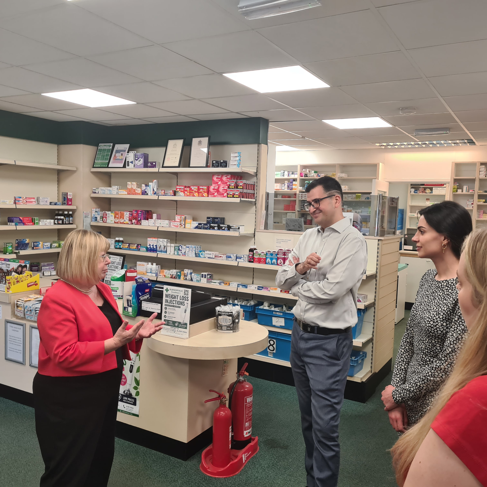 Liz Twist MP speaking with the pharmacist during the visit